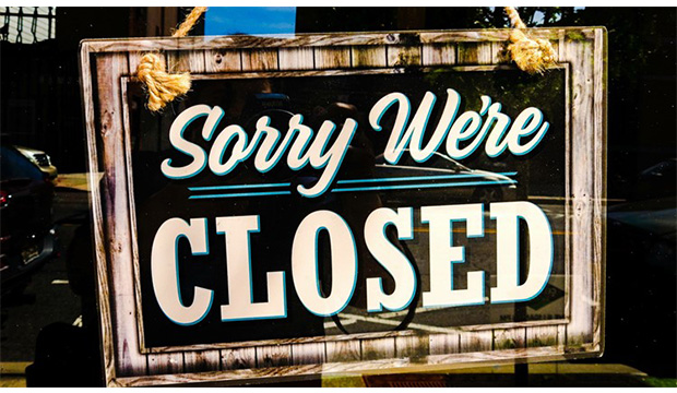 Sign on door with "Sorry, We're Closed"