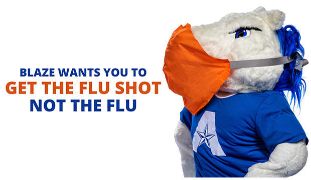 Blaze, UTA mascot, wearing a mask, with "Get The Flu Shot, Not The Flu."