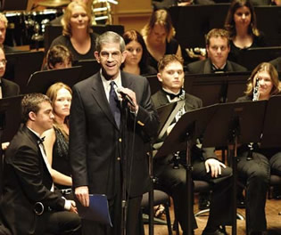 Spaniolo addresses the audience at music Professor Ray Lichtenwalter's retirement concert