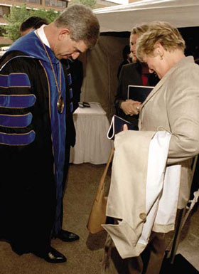 President Spaniolo shows off his boots