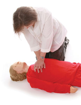 Nurse practices CPR on a dummy