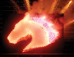 UTA's mascot, Blaze, lit by fireworks