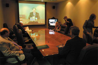Photo of teleconference between UT Arlington President James D. Spaniolo and UT Dallas President David Daniel